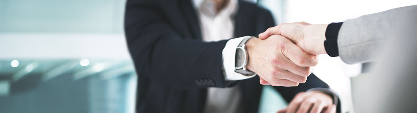 Business dressed men shaking hands, one had has a nice watch on